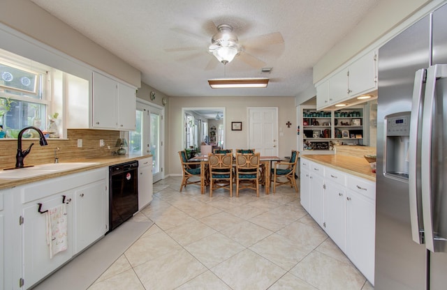 12211 3rd St, Santa Fe, TX 77510 - kitchen featuring stainless steel refrigerator with ice dispenser, black dishwasher, a sink, light countertops, and white cabinets