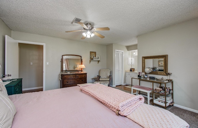 12211 3rd St, Santa Fe, TX 77510 - bedroom featuring baseboards, a closet, a textured ceiling, and ceiling fan