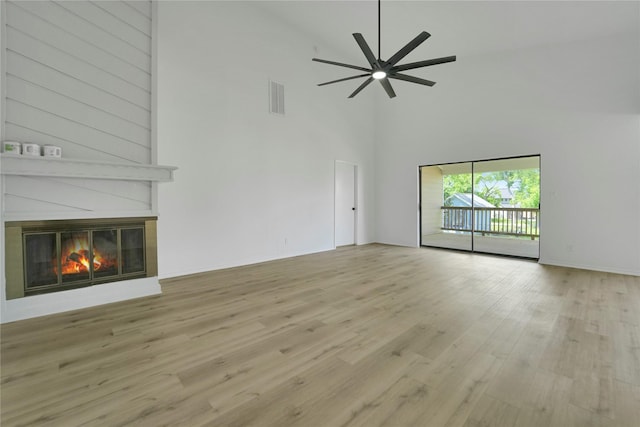 964 Lake View Dr, Montgomery, TX 77356 - unfurnished living room with high vaulted ceiling, wood finished floors, a fireplace, and ceiling fan