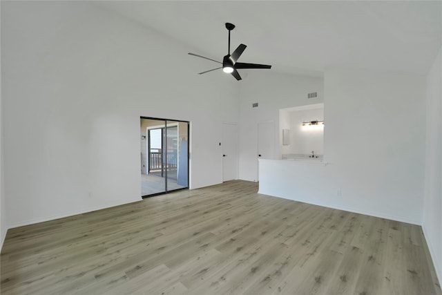 964 Lake View Dr, Montgomery, TX 77356 - unfurnished living room featuring a ceiling fan, light wood finished floors, high vaulted ceiling, and baseboards