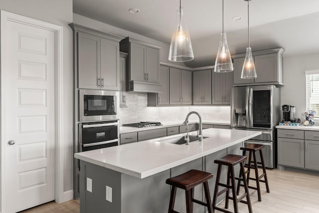 19227 Seabiscuit Stable Trl, Tomball, TX 77377 - kitchen featuring appliances with stainless steel finishes, gray cabinetry, tasteful backsplash, a sink, and recessed lighting