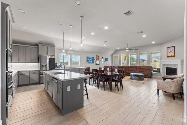 19227 Seabiscuit Stable Trl, Tomball, TX 77377 - kitchen with gray cabinetry, a sink, stainless steel refrigerator with ice dispenser, healthy amount of natural light, and recessed lighting