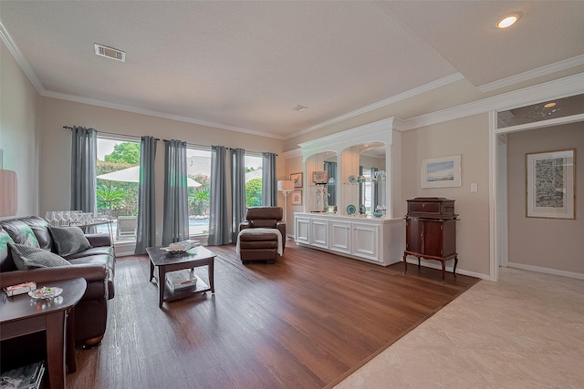 5807 Juniper Knoll Ln, Houston, TX 77345 - living room with crown molding, baseboards, wood finished floors, and a textured ceiling