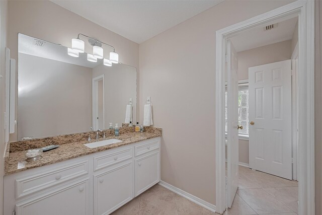 5807 Juniper Knoll Ln, Houston, TX 77345 - bathroom with vanity, tile patterned flooring, and baseboards