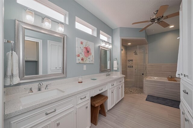 5807 Juniper Knoll Ln, Houston, TX 77345 - full bath featuring a shower stall, double vanity, a garden tub, ceiling fan, and a textured ceiling