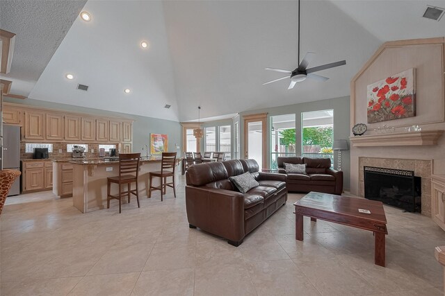 5807 Juniper Knoll Ln, Houston, TX 77345 - living room featuring ceiling fan, a tiled fireplace, high vaulted ceiling, and recessed lighting