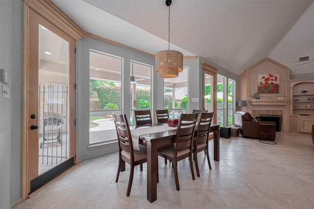 5807 Juniper Knoll Ln, Houston, TX 77345 - dining space featuring lofted ceiling, a fireplace, and light tile patterned floors