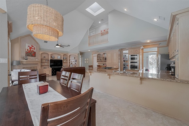 5807 Juniper Knoll Ln, Houston, TX 77345 - dining space with a ceiling fan, built in features, high vaulted ceiling, a skylight, and recessed lighting