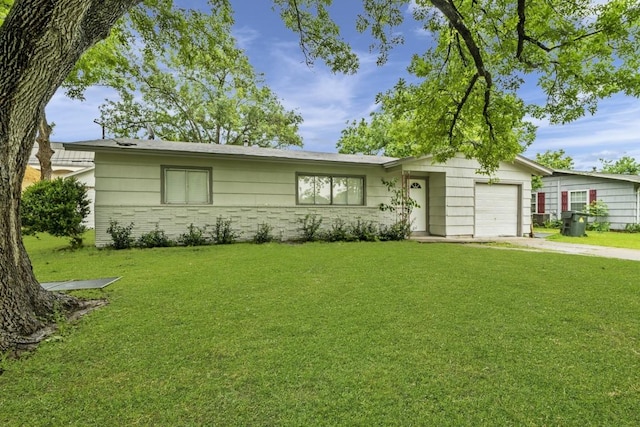 207 W Saunders St, League City, TX 77573 - single story home featuring an attached garage, concrete driveway, a front yard, and brick siding