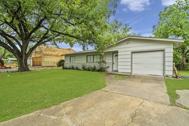207 W Saunders St, League City, TX 77573 - ranch-style house with a garage, concrete driveway, and a front lawn