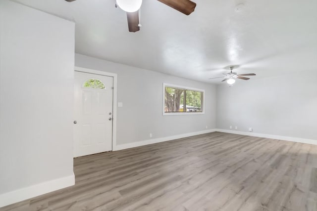 207 W Saunders St, League City, TX 77573 - unfurnished living room with a ceiling fan, baseboards, and light wood-style flooring