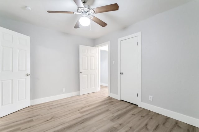 207 W Saunders St, League City, TX 77573 - unfurnished bedroom with baseboards, wood finished floors, and ceiling fan