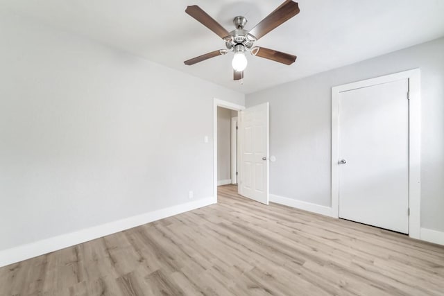 207 W Saunders St, League City, TX 77573 - unfurnished bedroom with wood finished floors, baseboards, and ceiling fan