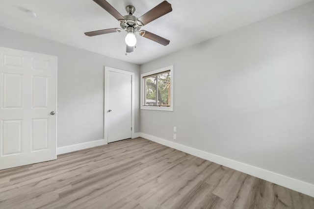 207 W Saunders St, League City, TX 77573 - unfurnished bedroom featuring baseboards, light wood-type flooring, a closet, and ceiling fan