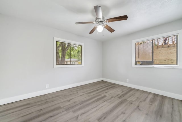 207 W Saunders St, League City, TX 77573 - empty room with wood finished floors, baseboards, and ceiling fan