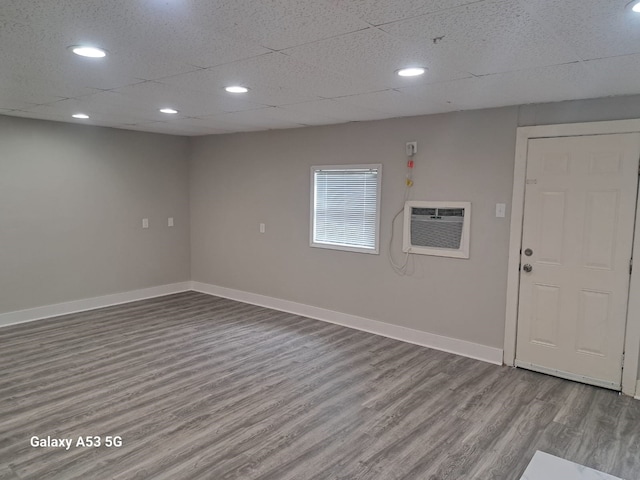 207 W Saunders St, League City, TX 77573 - unfurnished room featuring wood finished floors, baseboards, recessed lighting, and an AC wall unit