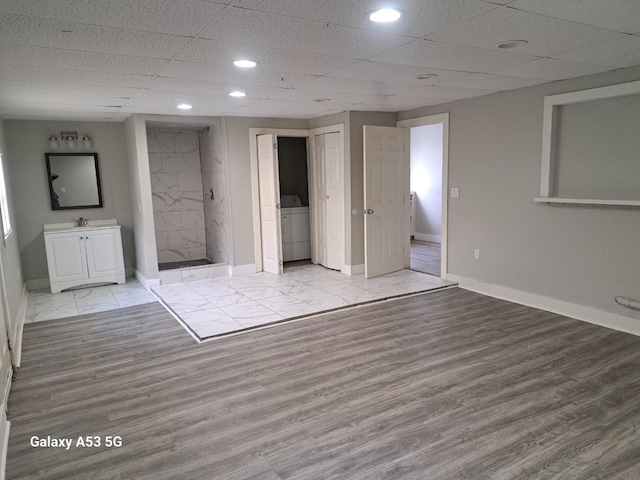 207 W Saunders St, League City, TX 77573 - unfurnished bedroom with washer / dryer, baseboards, wood finished floors, a sink, and recessed lighting