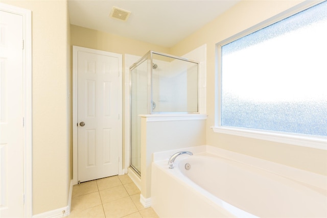 9726 Angleside Ln, Sugar Land, TX 77498 - bathroom featuring a stall shower, tile patterned flooring, a bath, and baseboards