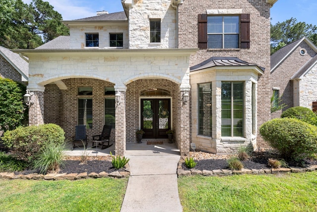 15557 Crown Oaks Dr, Montgomery, TX 77316 - view of front of home featuring french doors, brick siding, and a shingled roof
