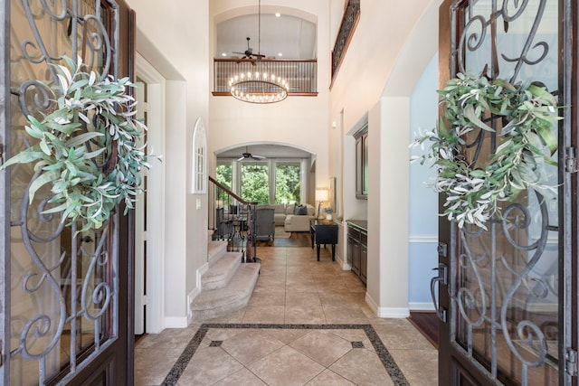 15557 Crown Oaks Dr, Montgomery, TX 77316 - foyer with a high ceiling, stairway, inlaid floor details, baseboards, and a chandelier