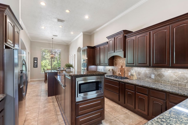 15557 Crown Oaks Dr, Montgomery, TX 77316 - kitchen featuring stainless steel appliances, a chandelier, a kitchen island, light tile patterned floors, and recessed lighting