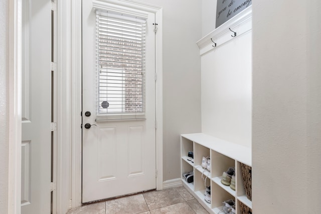 15557 Crown Oaks Dr, Montgomery, TX 77316 - mudroom featuring light tile patterned floors and baseboards