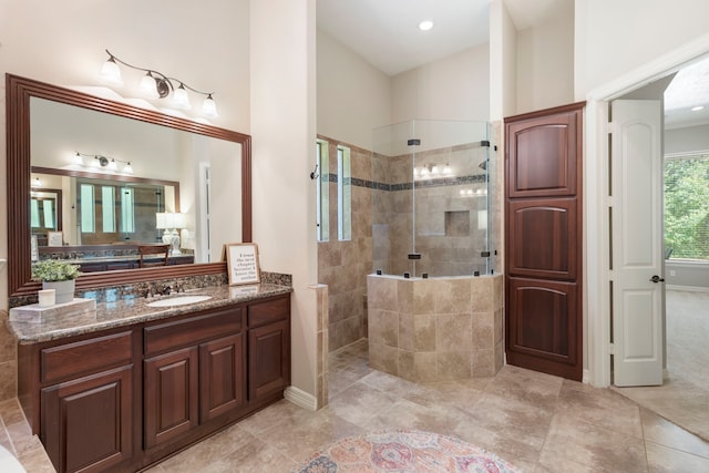 15557 Crown Oaks Dr, Montgomery, TX 77316 - full bathroom with walk in shower, vanity, vaulted ceiling, tile patterned flooring, and baseboards