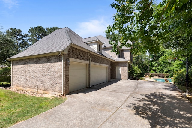 15557 Crown Oaks Dr, Montgomery, TX 77316 - view of home's exterior with an attached garage, concrete driveway, brick siding, an outdoor pool, and a shingled roof