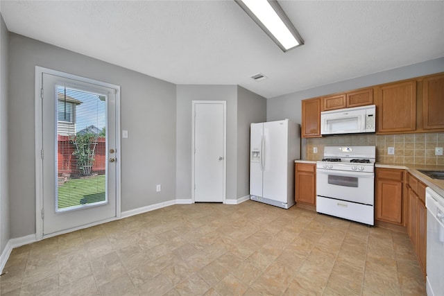 kitchen featuring white appliances, light countertops, decorative backsplash, brown cabinets, and baseboards