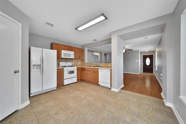 kitchen with white appliances, light countertops, ceiling fan, backsplash, and baseboards