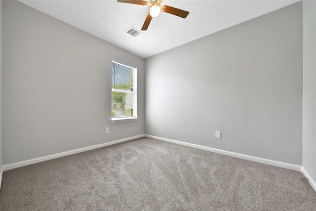 carpeted spare room with a ceiling fan and baseboards