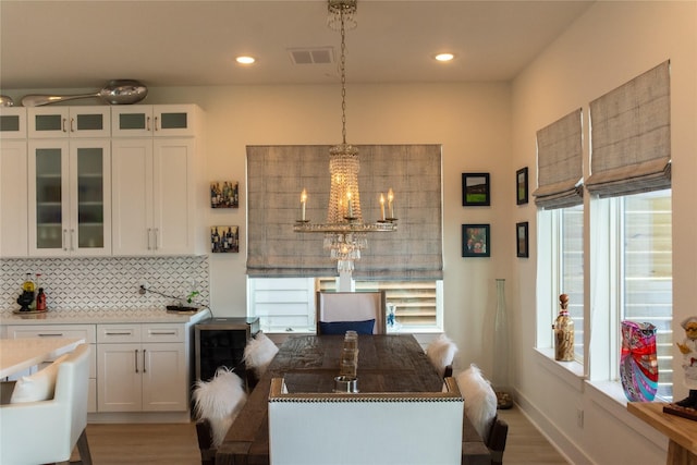 29 Cmdr Runco Ln, Taylor Lake Village, TX 77586 - dining room with wood finished floors, a chandelier, recessed lighting, and baseboards