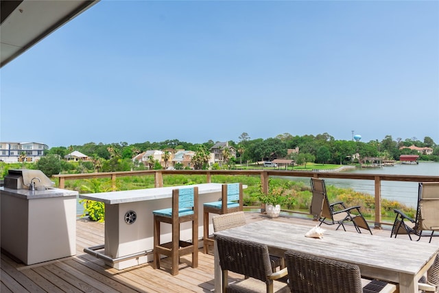 29 Cmdr Runco Ln, Taylor Lake Village, TX 77586 - deck featuring outdoor dining area, a water view, and area for grilling