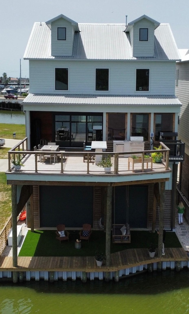 29 Cmdr Runco Ln, Taylor Lake Village, TX 77586 - back of house featuring a water view and metal roof
