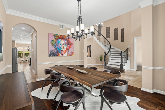 12011 Charlottes Bequest Cir, Cypress, TX 77433 - dining room featuring a chandelier, baseboards, ornamental molding, stairway, and arched walkways