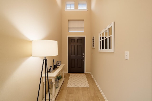 31550 Elkcreek Bend Dr, Hockley, TX 77447 - foyer featuring a towering ceiling, light tile patterned flooring, and baseboards
