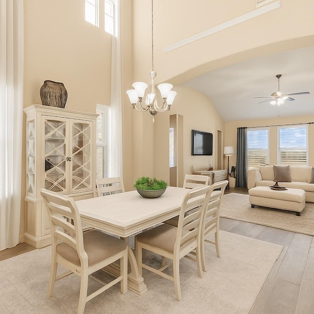 31550 Elkcreek Bend Dr, Hockley, TX 77447 - dining area with light wood finished floors, a chandelier, lofted ceiling, and ceiling fan