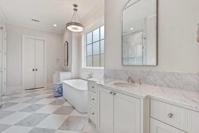 bathroom with crown molding, a stall shower, a soaking tub, two vanities, and baseboards