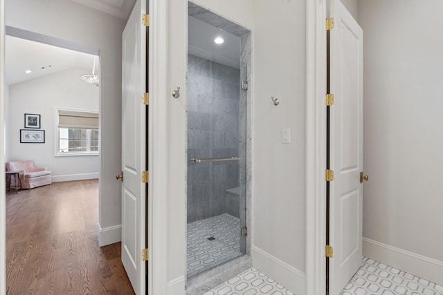 full bath with a stall shower, baseboards, wood finished floors, recessed lighting, and vaulted ceiling