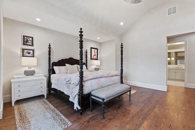 bedroom featuring wood finished floors, baseboards, recessed lighting, lofted ceiling, and a sink