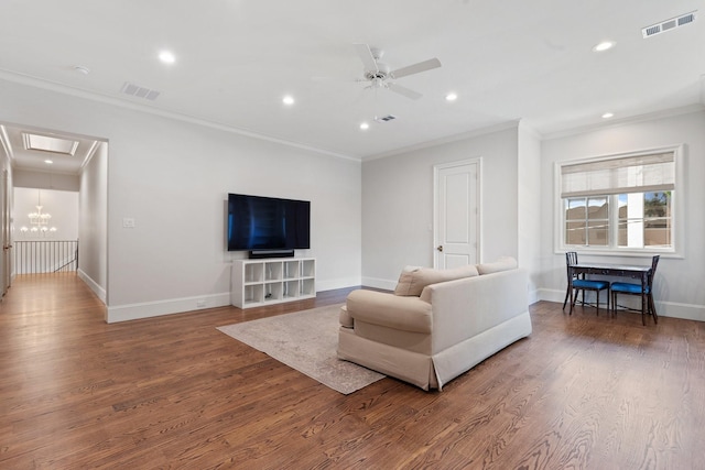 living area with crown molding, recessed lighting, a ceiling fan, baseboards, and wood finished floors