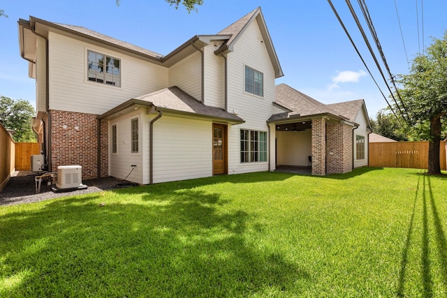 back of property with brick siding and a shingled roof