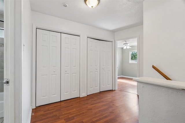 15623 Ensenada Dr, Houston, TX 77083 - unfurnished bedroom featuring two closets, dark wood finished floors, and baseboards