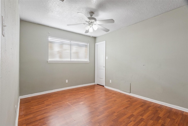 15623 Ensenada Dr, Houston, TX 77083 - spare room featuring wood finished floors, a ceiling fan, baseboards, and a textured ceiling