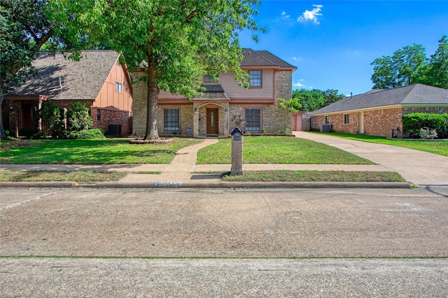 15623 Ensenada Dr, Houston, TX 77083 - view of front of home featuring brick siding, a front lawn, and central air condition unit