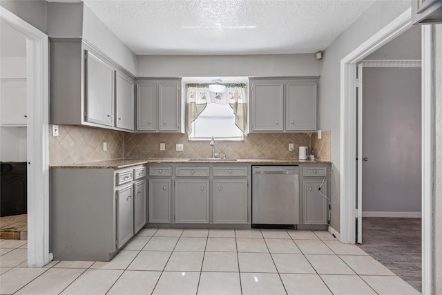 15623 Ensenada Dr, Houston, TX 77083 - kitchen with stainless steel dishwasher, gray cabinets, a sink, and a textured ceiling