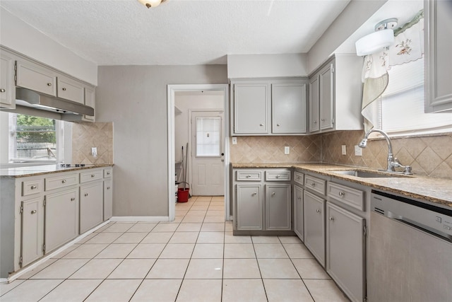 15623 Ensenada Dr, Houston, TX 77083 - kitchen with dishwasher, a sink, under cabinet range hood, gray cabinets, and decorative backsplash