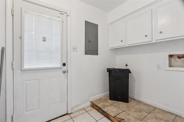 15623 Ensenada Dr, Houston, TX 77083 - clothes washing area with electric panel, hookup for an electric dryer, baseboards, cabinet space, and light tile patterned flooring