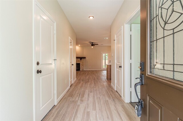14606 W 6th St, Santa Fe, TX 77517 - foyer featuring a fireplace, ceiling fan, light wood-type flooring, recessed lighting, and baseboards
