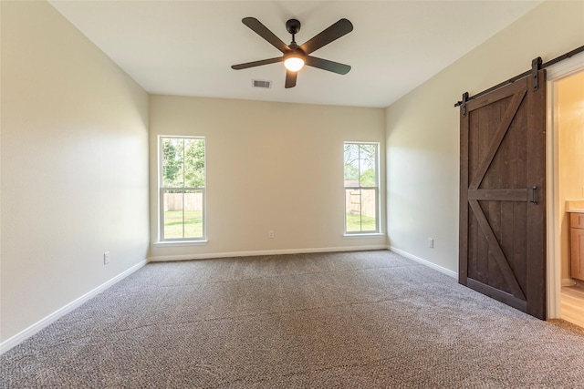 14606 W 6th St, Santa Fe, TX 77517 - unfurnished bedroom featuring a barn door, carpet, and baseboards